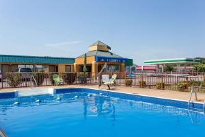 a swimming pool in front of a hotel at Days Inn by Wyndham Dickson in Dickson