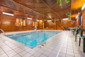 a large swimming pool in a wooden building with at Days Inn by Wyndham Topeka in Topeka