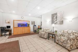 a waiting room with two chairs and a desk at Days Inn by Wyndham St Clairsville in Saint Clairsville