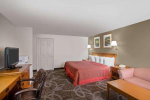 A television and/or entertainment centre at Days Inn by Wyndham Provo