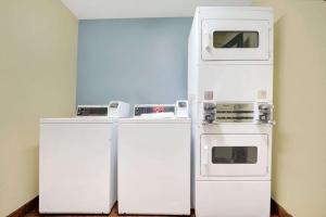 a kitchen with two microwaves and two refrigerators at Days Inn by Wyndham Albuquerque West in Albuquerque