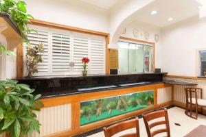 a kitchen with a fish tank on a counter at Days Inn by Wyndham Alhambra CA in Alhambra