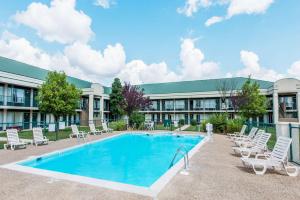 a swimming pool in front of a building at Days Inn by Wyndham Elizabethtown in Elizabethtown