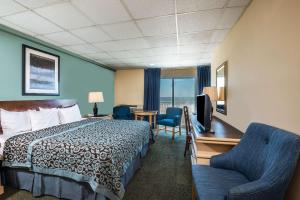 a hotel room with a bed and a desk and a chair at Days Inn by Wyndham Atlantic City Oceanfront-Boardwalk in Atlantic City