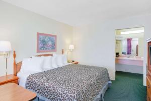 a hotel room with a bed and a bathroom at Days Inn by Wyndham Newport in Newport