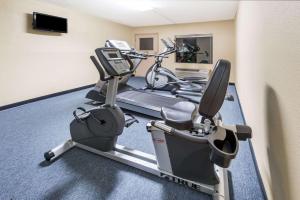 a gym with a treadmill and a bike in a room at Days Inn by Wyndham Lexington Southeast in Lexington