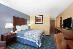 A bed or beds in a room at Days Inn by Wyndham Grand Island