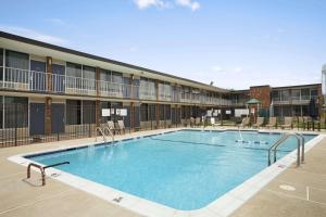 a large swimming pool in front of a building at Days Inn of Frederick by Wyndham in Frederick