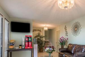 a living room with a couch and a flat screen tv at Days Inn by Wyndham San Marcos in San Marcos