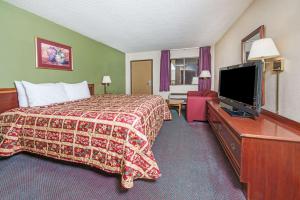 a hotel room with a bed and a flat screen tv at Days Inn by Wyndham New Market in New Market