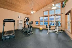 a gym with two treadmills and exercise bikes in a room at Days Inn by Wyndham International Falls in International Falls