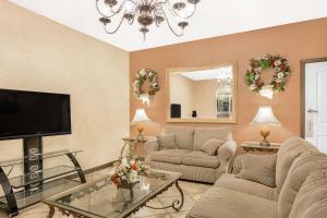 a living room with a flat screen tv and furniture at Meridian Inn Hotel in Meridian