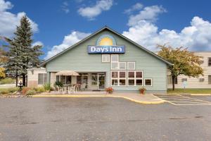 a house with a sign on the front of it at Days Inn by Wyndham International Falls in International Falls