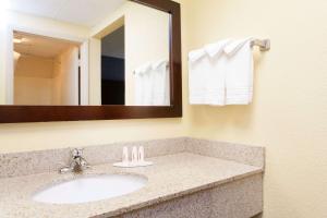 
a bathroom with two sinks and a mirror at Days Inn by Wyndham Wilkes Barre in Wilkes-Barre
