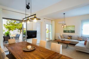 a living room with a table and a couch at SP villa in Agios Onoufrios