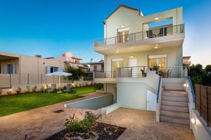 a house with a staircase and a yard at SP villa in Agios Onoufrios