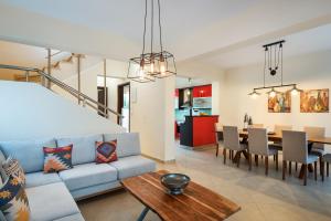 a living room and dining room with a couch and a table at SP villa in Agios Onoufrios