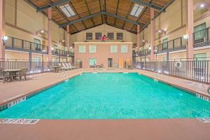 a large swimming pool in a large building at Days Inn by Wyndham Lubbock South in Lubbock