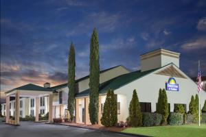 a rendering of the front of a hotel at Days Inn & Suites by Wyndham Peachtree Corners Norcross in Norcross