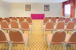 a room with rows of chairs in a room at Days Inn & Suites by Wyndham Laurel Near Fort Meade in Laurel