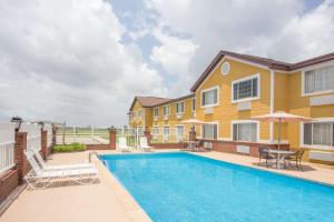 a swimming pool in front of a house at Days Inn by Wyndham Lake Village in Lake Village