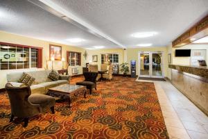 a living room with a couch and chairs on a rug at Days Inn by Wyndham Yakima in Yakima