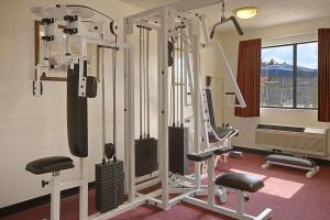 a gym with several tread machines in a room at Days Inn by Wyndham Fresno South in Fresno