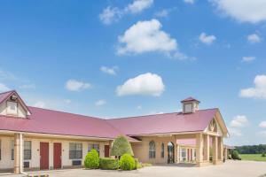 a large building with a purple roof at Days Inn by Wyndham Lonoke in Lonoke
