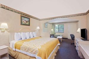 a hotel room with a bed and a television at Your Place Inn in Millington +3 photos