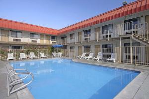 a large swimming pool in front of a hotel at Days Inn by Wyndham Fresno South in Fresno