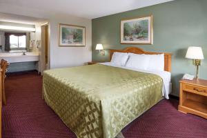 a hotel room with a large bed and a window at Days Inn by Wyndham in San Bernardino in San Bernardino