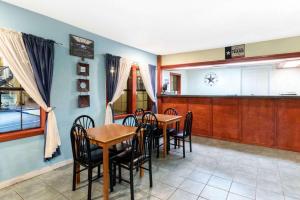 a dining room with two tables and chairs at Days Inn by Wyndham Snyder in Snyder