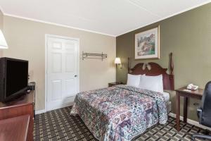 勒諾市的住宿－勒諾城戴斯酒店，配有一张床和一台平面电视的酒店客房