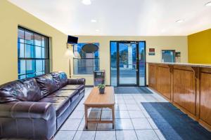 a living room with a couch and a table at Days Inn by Wyndham McAllen in McAllen