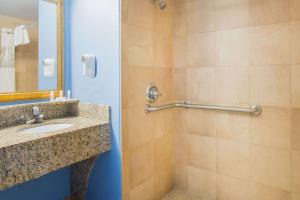a bathroom with a shower and a sink at Days Inn by Wyndham New Haven in New Haven