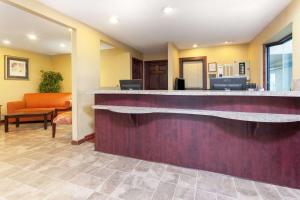 a hotel lobby with a reception counter and a waiting room at Days Inn by Wyndham Maumee/Toledo in Maumee
