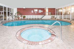 a large swimming pool in the middle of a building at Days Inn by Wyndham Evanston WY in Evanston