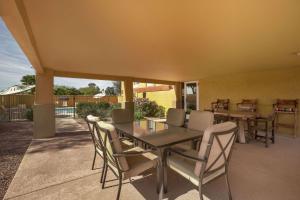 a dining table and chairs on a patio at Days Inn & Suites by Wyndham Surprise in Surprise