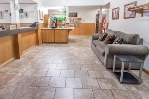 a living room with a couch and a kitchen at Days Inn by Wyndham Corvallis in Corvallis