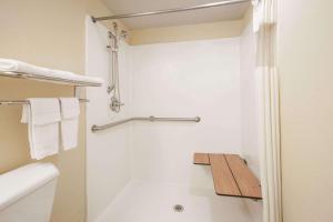 a bathroom with a toilet and a shower at Days Inn by Wyndham Okemah in Okemah