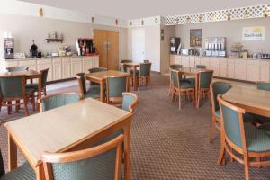 un restaurante con mesas, sillas y una barra en Days Inn by Wyndham Hillsboro TX, en Hillsboro