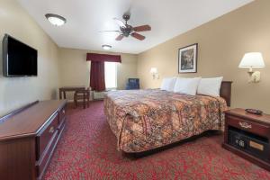 A bed or beds in a room at Days Inn by Wyndham St Peters/St Charles