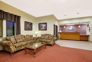 a large living room with a couch and a table at Days Inn by Wyndham Fairfield in Fairfield