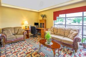 a living room filled with furniture and a large window at Days Inn by Wyndham Salem in Salem