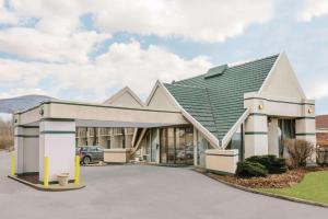 a large building with a green roof at Days Inn by Wyndham Rutland/Killington Area in Rutland