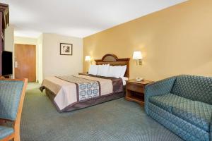 A bed or beds in a room at Days Inn by Wyndham Burlington East