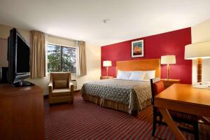 a hotel room with a bed and a desk at Colony Inn in Kent