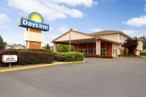 a days inn sign in front of a building at Days Inn by Wyndham Kent 84th Ave in Kent