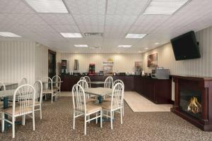 a waiting room with a table and chairs and a fireplace at Days Inn by Wyndham Grantville in Grantville