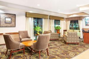 a lobby with chairs and a table at Days Inn by Wyndham Brewerton/ Syracuse near Oneida Lake in Brewerton